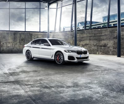 Sleek White BMW Sedan Displayed in Modern Industrial Setting Cinematic View image