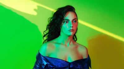 Glamorous Woman in Shimmering Blue Top with Vibrant Studio Lighting image