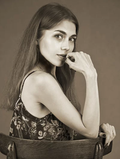 Vintage Sepia Portrait: Thoughtful Young Woman with Hand on Chin image