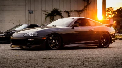 Iconic Japanese Sports Cars Parked in Golden Hour Sunset on Asphalt image