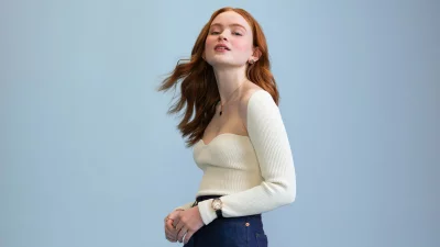 Confident Redhead Woman in Chic Ribbed Top and Denim Posing Elegantly image
