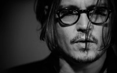 Pensive Black and White Portrait of Man with Glasses and Goatee image