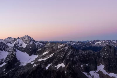 Majestic Snow-Capped Mountain Peaks at Twilight with Gradient Sky image