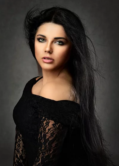 Captivating Woman with Windswept Dark Hair and Green Eyes image