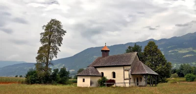 Historic Rural Church Bell Tower Amidst Lush Mountain Landscape image