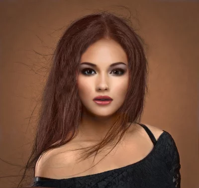 Captivating Young Woman with Long Brown Hair and Expressive Gaze image