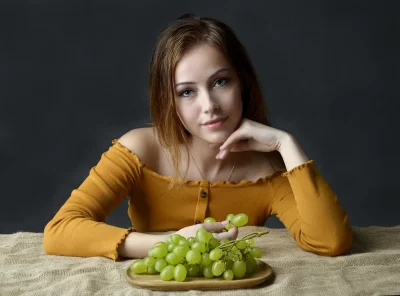 Captivating Young Woman in Off-Shoulder Top with Fresh Green Grapes image