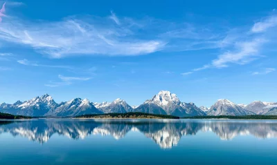Majestic Grand Teton Mountains Reflected in Serene Jackson Lake Under Clear Blue Sky image