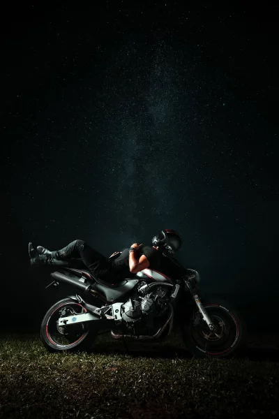 Relaxed Biker Gazing at Starry Sky on Motorcycle image