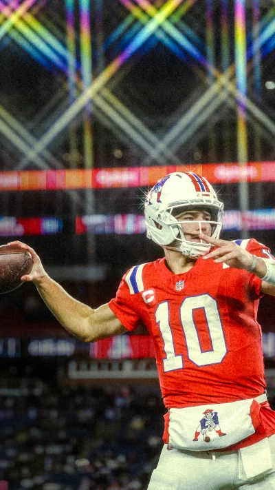 Professional American Football Quarterback Prepares to Throw During Intense Night Game image