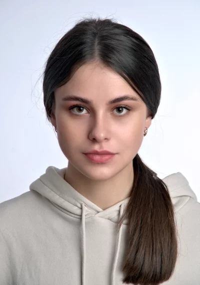 Confident Young Woman Looking Directly at Camera in Casual Hoodie Studio Shot image