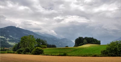 Vast Green Fields and Mountains Under Overcast Sky Rural Landscape image