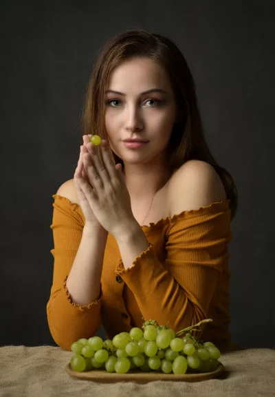 Young Woman Posing Delicately with Fresh Green Grapes image