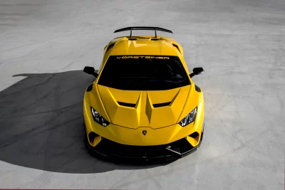 Stunning Yellow Lamborghini Huracan Supercar with Vörsteiner Aerodynamics on Concrete Surface image