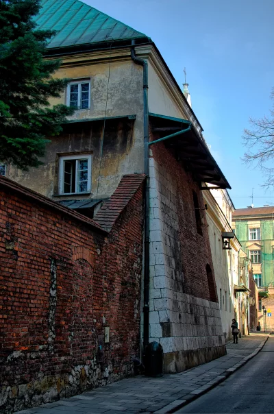 Woman Walking in Historic European Alleyway, Aged Buildings, Green Patina Roof image