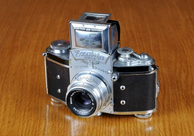 Antique Exakta Varex Film Camera with Pop-Up Viewfinder on Wood Surface image