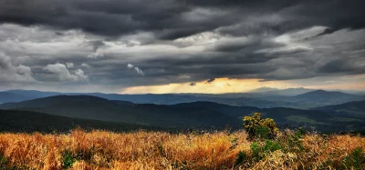 Dramatic Mountain Landscape with Golden Sunset Sky and Storm Clouds image