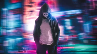 Anonymous Hacker Standing in Neon Cityscape, Digital Protest Concept image