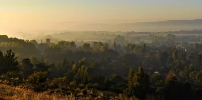 Misty European Village with Church Spire at Golden Sunrise image