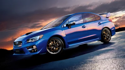 Sleek Blue Subaru WRX STI Sports Car at Sunset on Wet Asphalt image