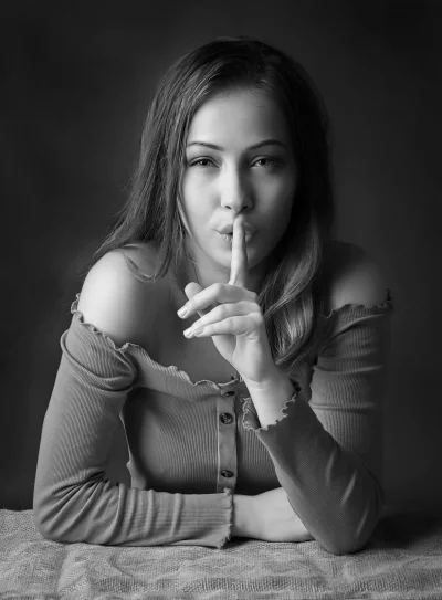 Young Woman Signaling Silence in Monochrome Portrait image