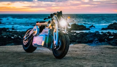 Cutting-Edge Electric Motorcycle on Coastal Rock Shore at Golden Sunset image