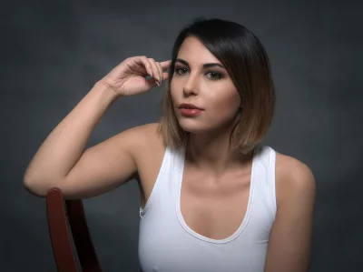 Pensive Young Woman in White Tank Top with Short Ombre Hair Studio Portrait image