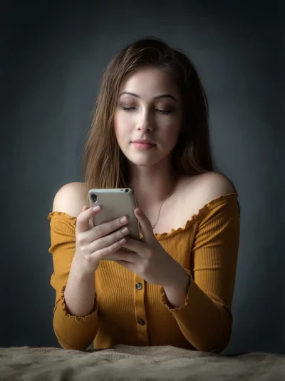 Young Woman Serene Smartphone Focus in Off-Shoulder Ribbed Top image