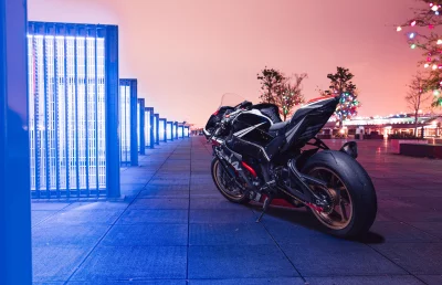 Sleek Sport Motorcycle Parked in Urban Scene with Vibrant Blue Neon Lights at Night image