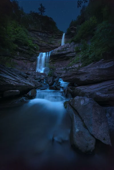 Ethereal Night Waterfall, Starry Sky, Smooth Water Flow, Rocky Forest Landscape image