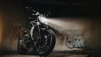 Powerful Black Motorcycle Illuminates Dark Urban Tunnel with Headlight Beam image