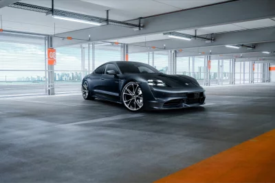 Sleek Dark Grey Porsche Taycan Electric Car in Modern Parking Garage image
