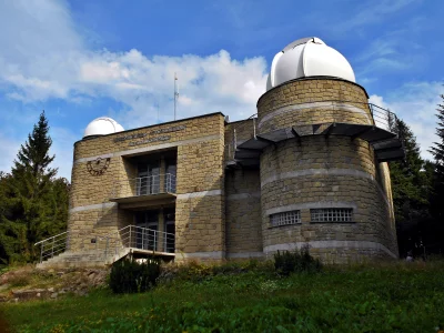 Historic Astronomical Observatory with Stone Architecture and White Domes Under Blue Sky image