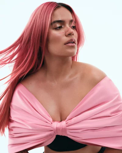 Glamorous Woman with Vibrant Pink Hair and Chic Pink Bow Top Posing Elegantly image
