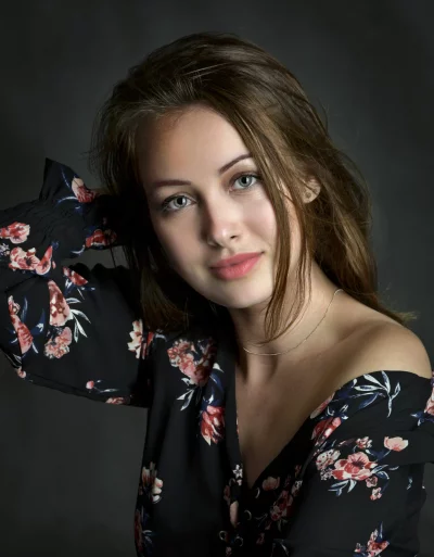 Portrait of Young Woman in Floral Off-Shoulder Top with Green Eyes image