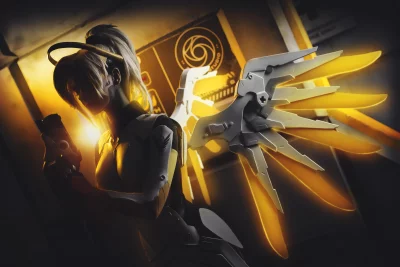 Powerful Female Sci-Fi Character with Radiant Golden Wings and Futuristic Weapon image
