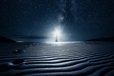 Cosmic Scene with a Radiant Silhouette on a Rippled Desert Plain Under Starry Sky image