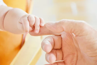 Newborn Baby Hand Grasping Adult Finger, Symbolizing Intergenerational Connection and Care image