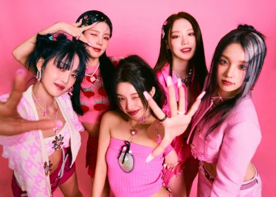 Vibrant K-pop Girl Group Posing in Pink Outfits on Trendy Studio Background image