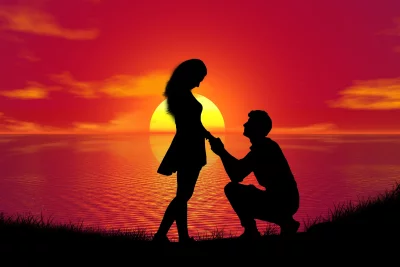Romantic Sunset Marriage Proposal: Man Kneeling to Woman by the Ocean Horizon image