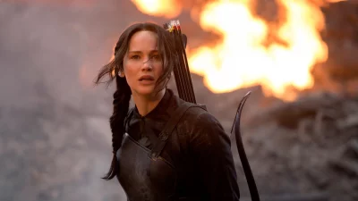 Determined Female Archer in Fiery Post-Apocalyptic Battle Scene with Bow and Quiver image