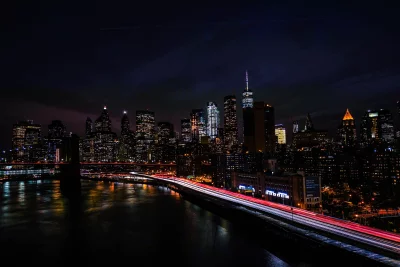 New York City Skyline Night with Brooklyn Bridge Long Exposure Light Trails image
