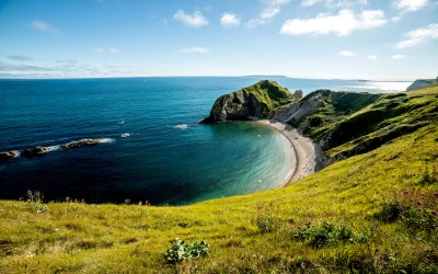 Stunning Coastal Landscape with Natural Arch and Turquoise Sea under Blue Sky image