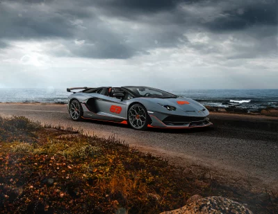Grey Lamborghini Aventador Sports Car by Ocean under Dramatic Cloudy Sky image