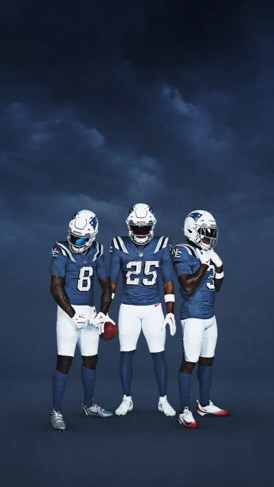 Three New England Patriots Football Players in Blue Uniforms Ready for Gameday