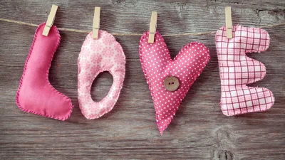 Handmade Fabric Letters Spelling LOVE on Rustic Wooden Background for Valentine's Day image