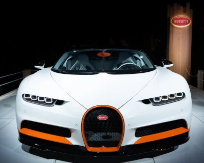 White Bugatti Chiron Sports Car with Vibrant Orange Accents image