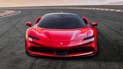 Sleek Red Performance Sports Car on Asphalt Racetrack with Blurred Background image