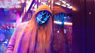 Blonde Woman in Hooded Sweatshirt and Glowing Neon Mask in Night City image