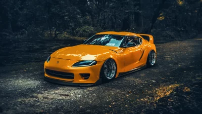 Vibrant Orange Toyota Supra Performance Car with Custom Wheels on Dark Road image